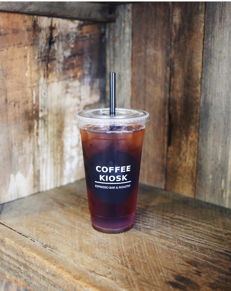 Iced Coffee Kiosk drink on a rustic wood counter